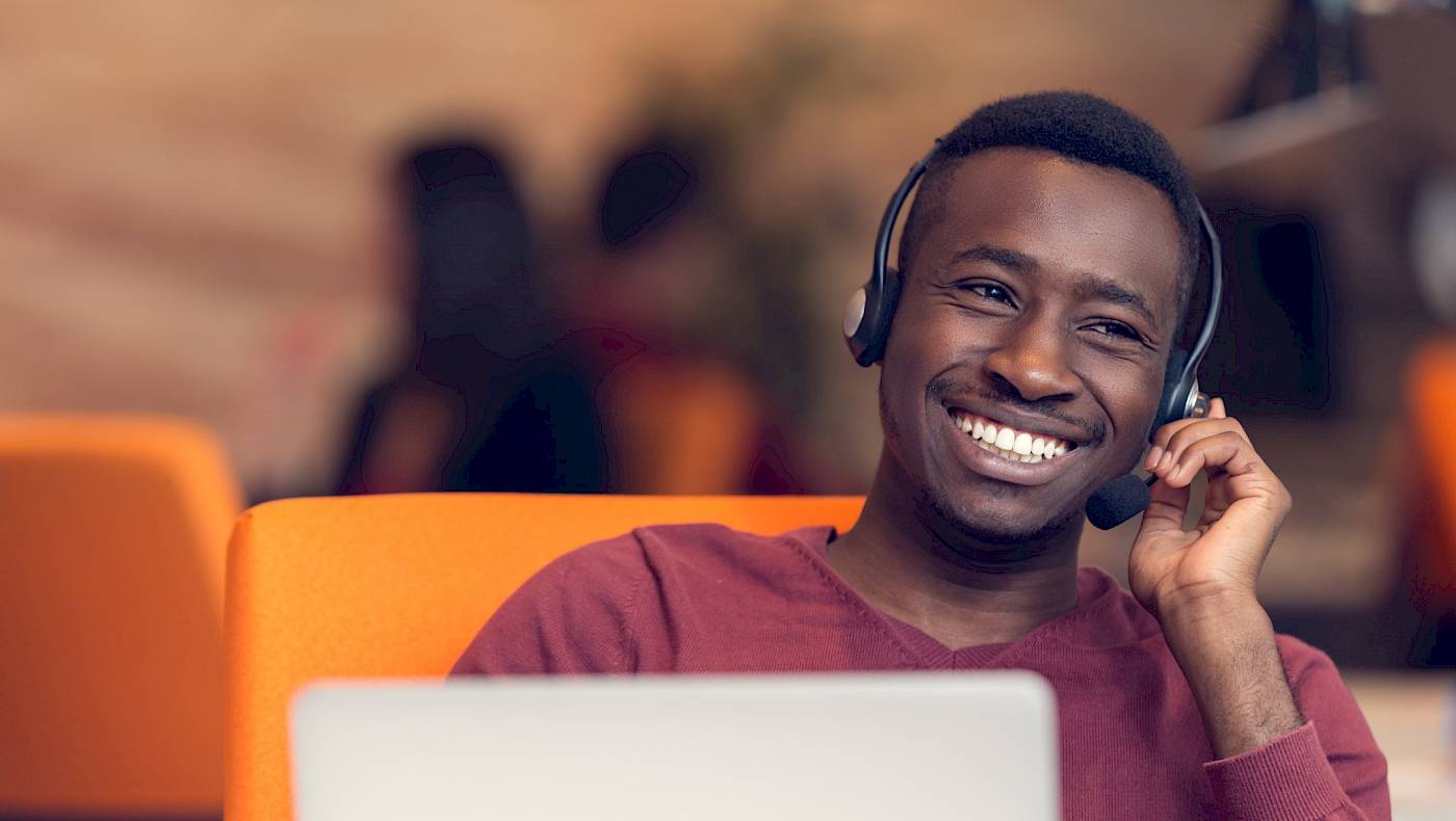 young smiling customer service agent wearing a headset