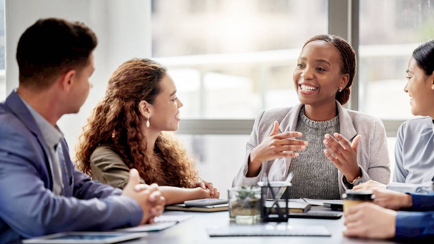 Confident woman leading a discussion with colleagues