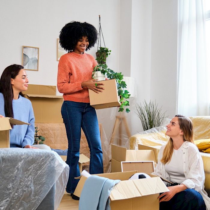 Young girls in new house with moving boxes smiling